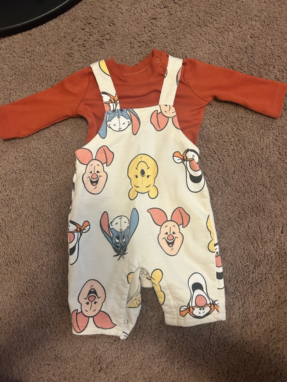 Disney Baby Cream romper with rust accents and multicolor characters